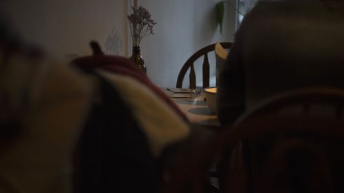 Rear view of man having food at home