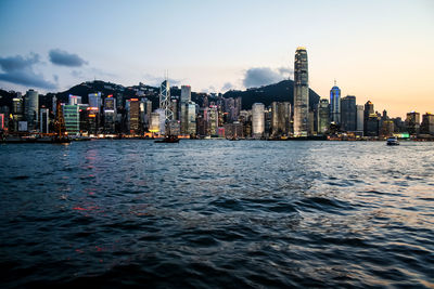 Victoria harbor against buildings in city