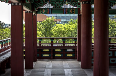 Corridor in traditional building by trees at michuhol park