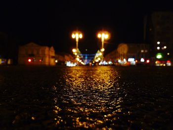 Illuminated city against sky at night