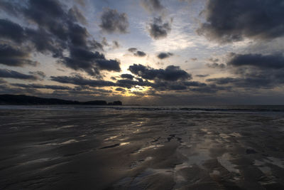 Scenic view of beach against sky during sunset