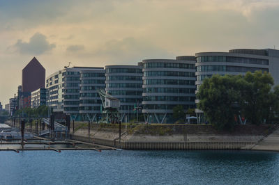 Buildings in city against sky at sunset