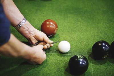 Cropped image of hands measuring balls while playing game