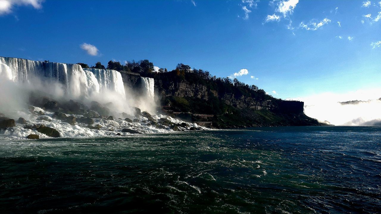 water, scenics - nature, beauty in nature, sky, body of water, nature, motion, environment, waterfall, sea, wave, travel destinations, travel, wind wave, coast, ocean, landscape, blue, land, tourism, cloud, outdoors, no people, rock, long exposure, splashing, water sports, tropical climate, holiday, cliff, sports, trip, terrain, vacation, non-urban scene, mountain, idyllic, day