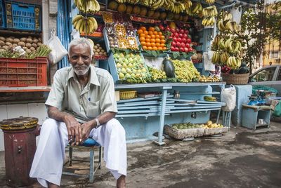 Full length of a man for sale at market stall