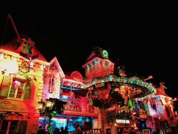 Low angle view of illuminated christmas lights at night