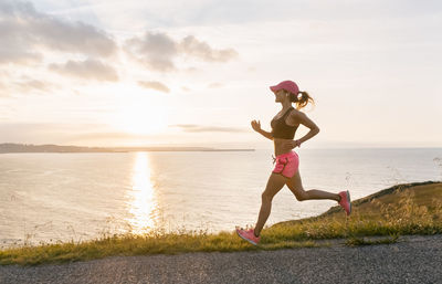 Young woman running at the sea