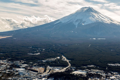 Aerial view of snowcapped mountains against sky