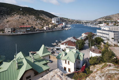  panoramic top view of the sea and boats. rocks and water and rooftops of town houses