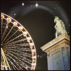 Low angle view of illuminated ferris wheel at night