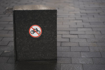 High angle view of road sign on footpath