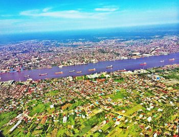 Aerial view of sea with cityscape in background