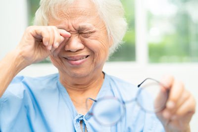 Asian senior old woman patient feel sad and cry when pain from sick 