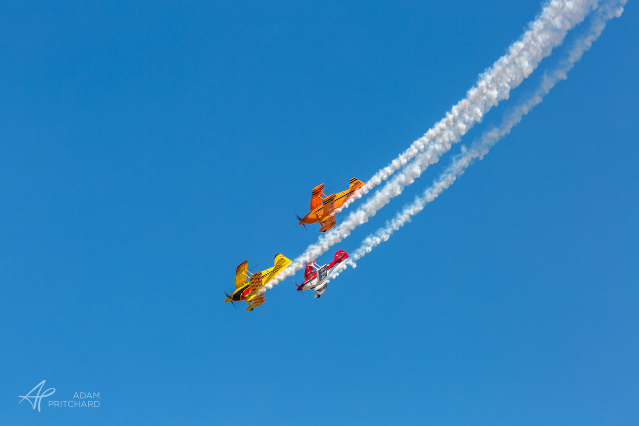 LOW ANGLE VIEW OF MAN AGAINST BLUE SKY