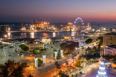 High angle view of illuminated buildings in city at night