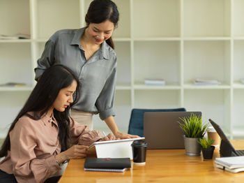 Female entrepreneurs using digital tablet at office