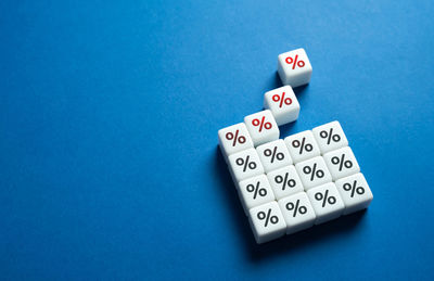 High angle view of dices on blue background