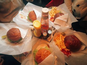 High angle view of burgers and fries on table