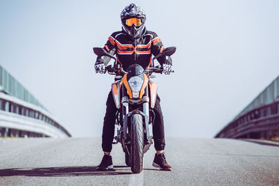 Man riding bicycle on bridge