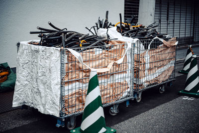 Garbage on street against buildings in city