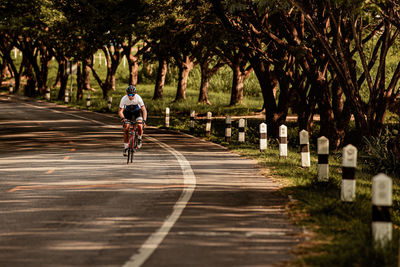 Man riding bicycle on road