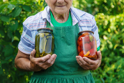 Midsection of woman holding drink