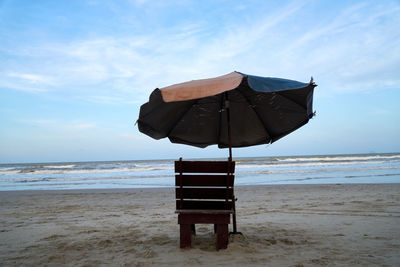 Lifeguard hut on beach against sky