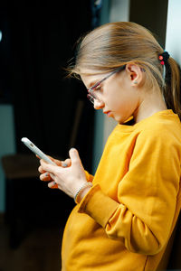 Midsection of woman holding smart phone