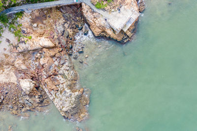 High angle view of rocks by sea