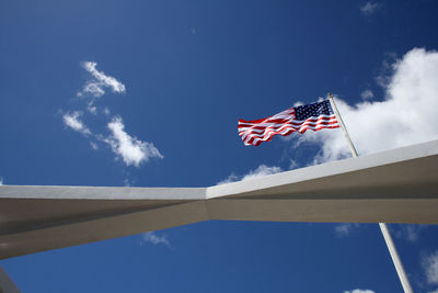 Low angle view of flag against blue sky