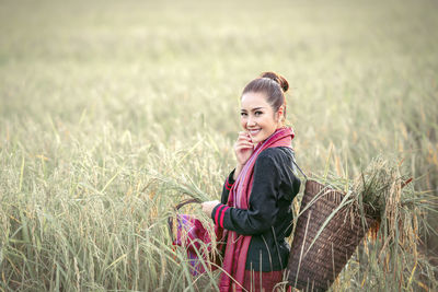 Portrait of smiling young woman on field