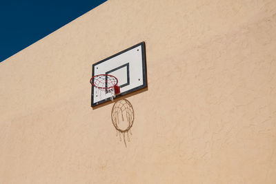 Low angle view of basketball hoop against wall