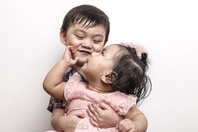 Portrait of cute baby against white background