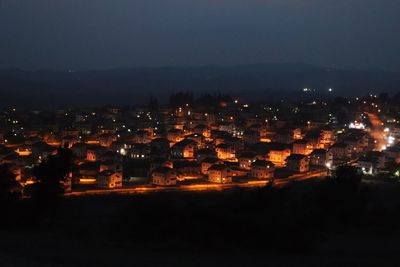 High angle view of illuminated buildings in city at night