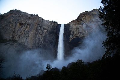 Scenic view of waterfall against sky