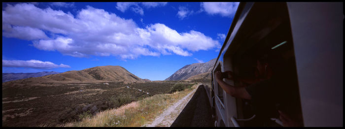 Panoramic view of road amidst mountains against sky