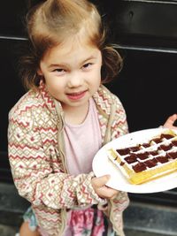 Close-up of cute girl holding ice cream