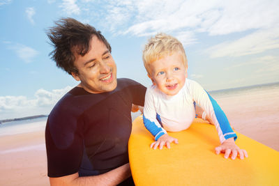 Portrait of smiling mother and daughter at beach