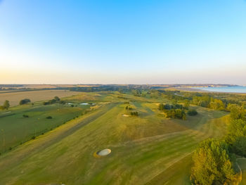 Scenic view of field against clear sky