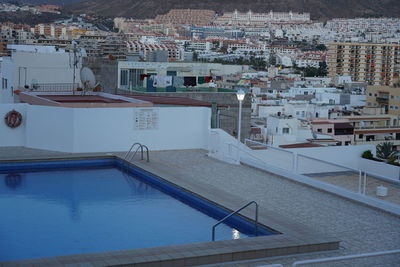 High angle view of swimming pool against buildings in city