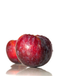 Close-up of red fruits on white background