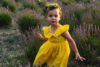Portrait of girl standing on field