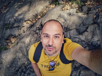 High angle portrait of man on rock