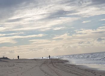 Scenic view of beach against sky during sunset