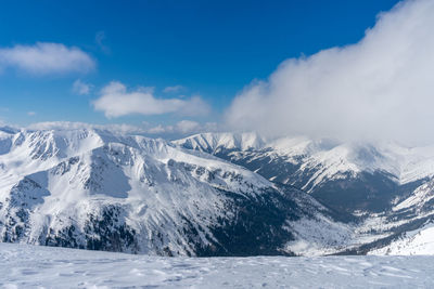 Scenic view of snowcapped mountains against sky