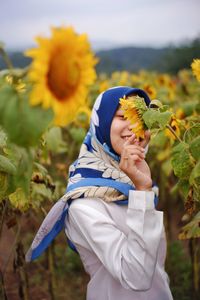 Low angle view of woman on sunflower field