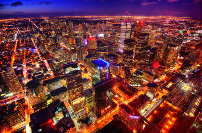 Aerial view of illuminated cityscape against sky at night