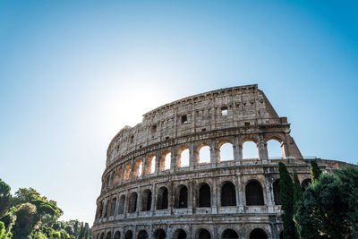 Low angle view of coliseum against clear sky