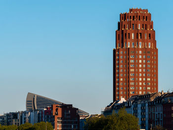 Modern buildings against clear blue sky