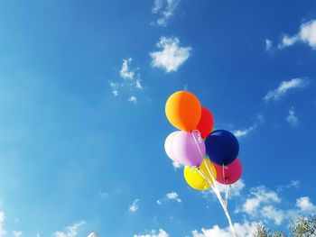 Low angle view of balloons against sky